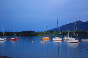 Boote auf dem Forggensee in der Abenddämmerung